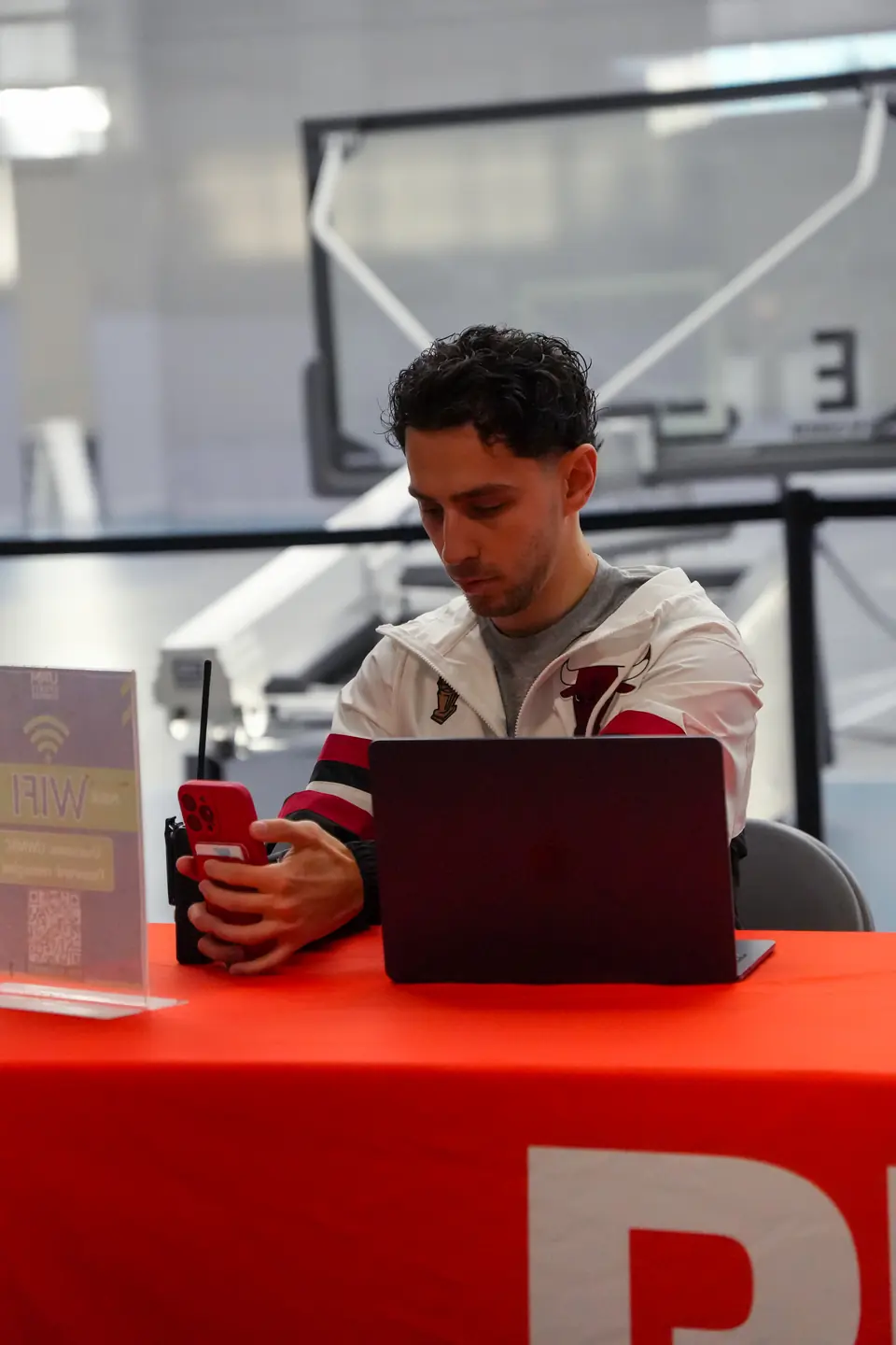 The RNKD check-in table, with a laptop and a phone on a red tablecloth