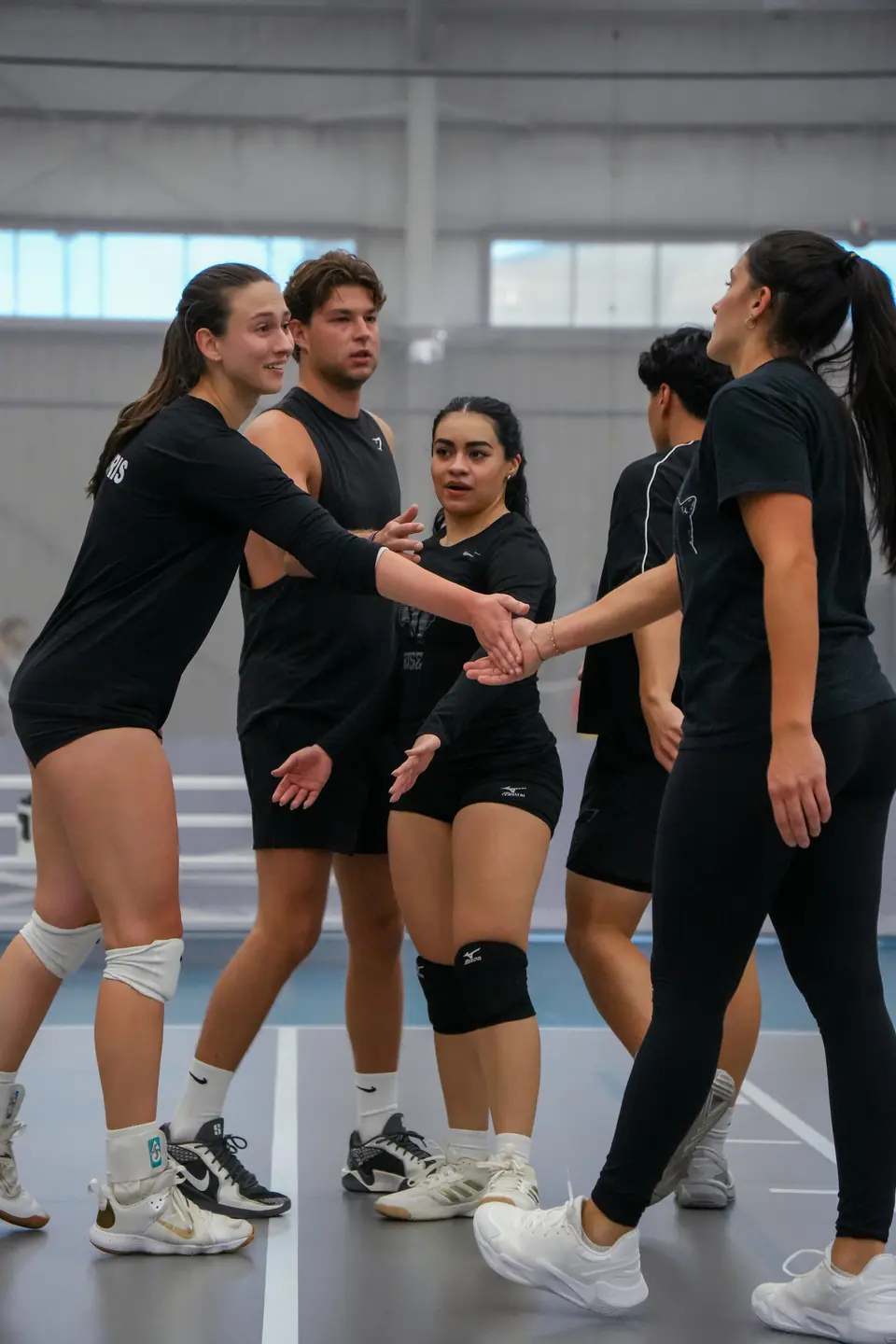 A team slapping hands between points