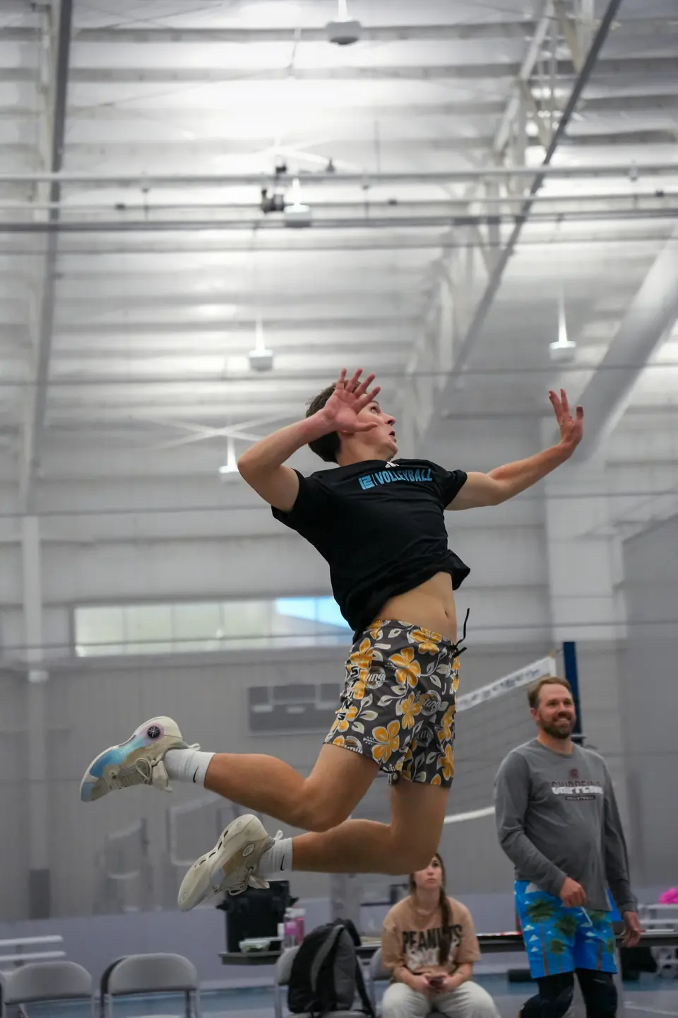 A player in the air for a jump serve